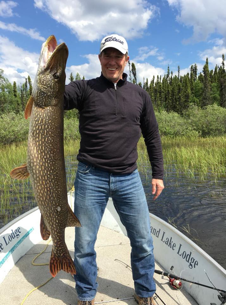 man at big sand in canada catching fish