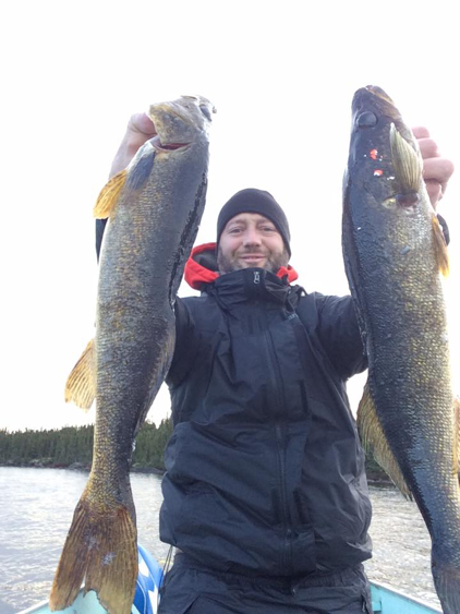 fisherman in canada with two walleye