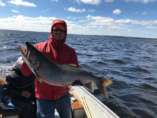 man at canada fishing lodge caught lake trout