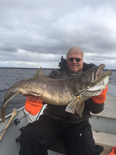 angler in canada with lake trout 46in